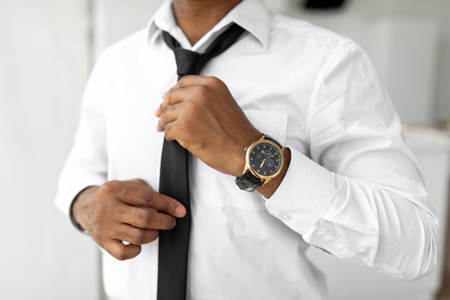 Unrecognizable African American Businessman Adjusting Tie, Closeup